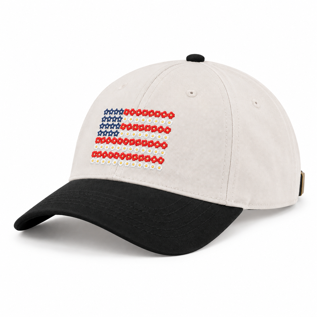 Star Floral American Flag Baseball Cap in Black three-quarter angle view showing cream structured six-panel cotton crown with embroidered floral flag detail, small ventilation eyelet on side, black bill with slight curve, and black top button on white background
