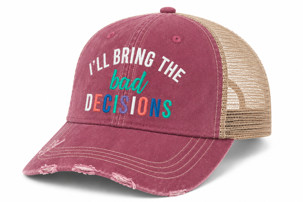 A distressed trucker-style baseball cap in dusty rose with beige mesh back panels. The front features the text 'I'LL BRING THE bad DECISIONS' in white, teal, and multicolor block letters.