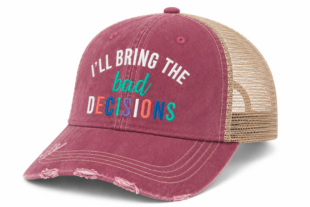 A distressed trucker-style baseball cap in dusty rose with beige mesh back panels. The front features the text 'I'LL BRING THE bad DECISIONS' in white, teal, and multicolor block letters.