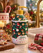 Molto Bella Gingerbread hand soap beside a sink with gingerbread cookies, candy canes, Christmas greenery, a plaid towel, and a gold faucet
