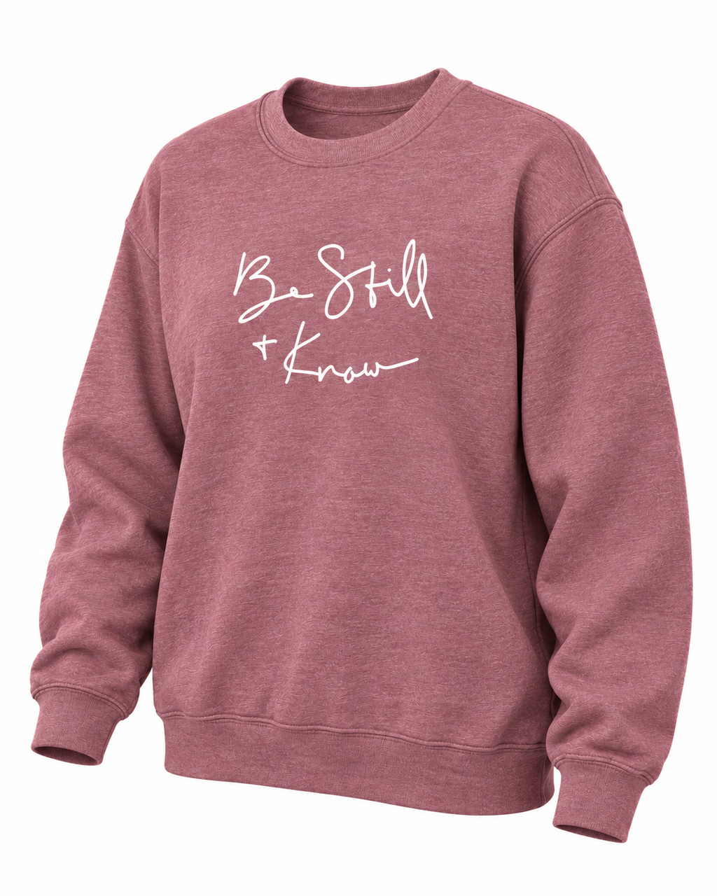 Angled front view of the dusty mauve Be Still + Know crewneck sweatshirt showing the white graphic and ribbed cuffs
