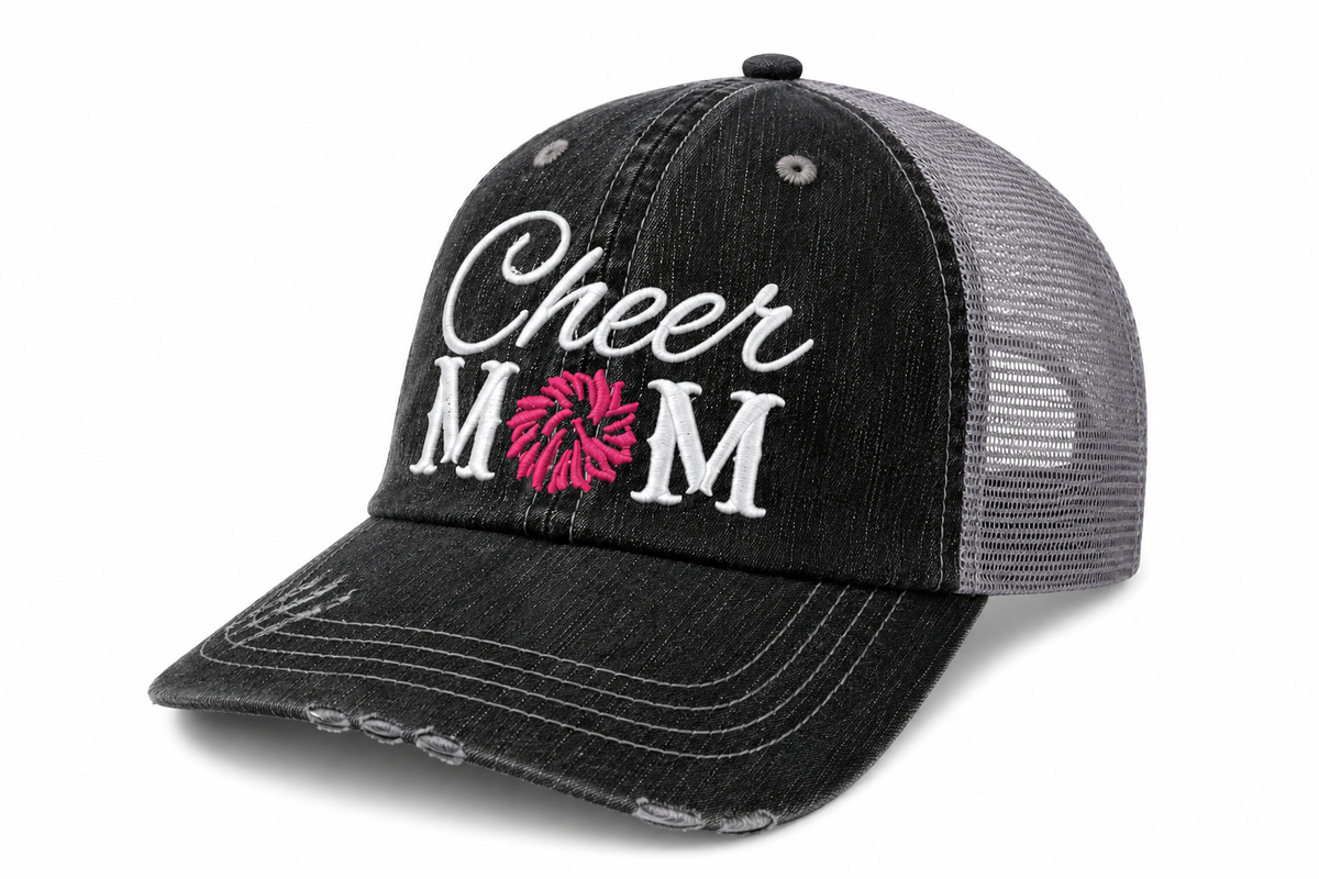 Side view of Cheer Mom trucker hat in distressed black with gray mesh back and white embroidered lettering, shown on a white background.
