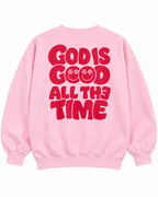 Full back view of the pink sweatshirt with red God Is Good All the Time lettering and daisy-eye smileys
