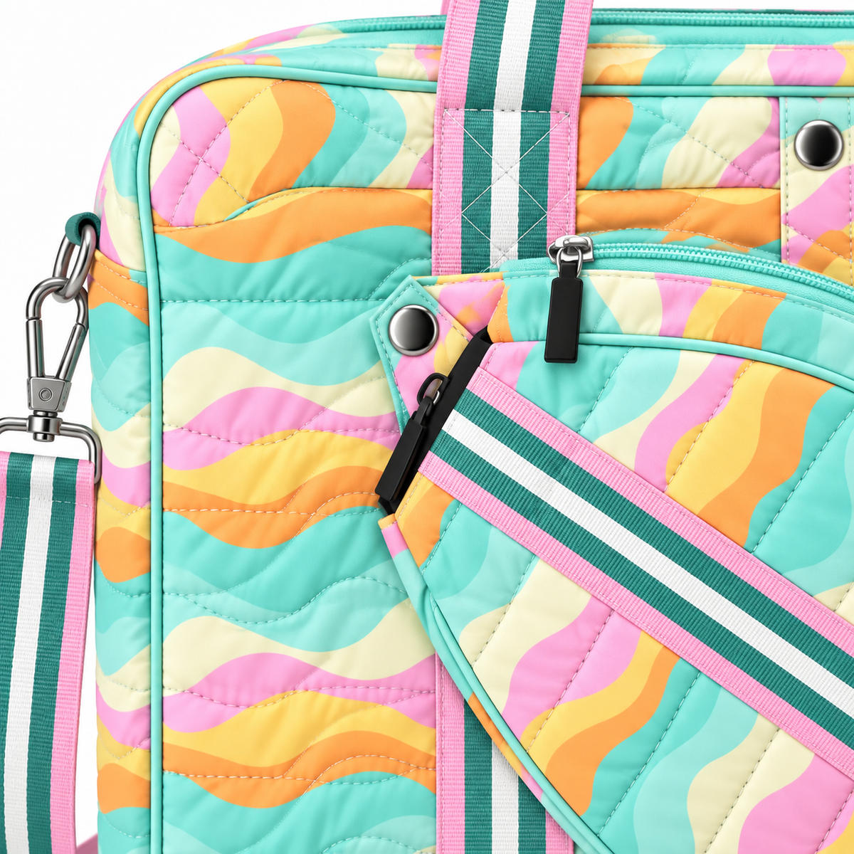Close-up of Pastel Wave Pickleball Bag showing silver snap paddle holder attachment point, removable quilted paddle holder with teal pink and white stripe strap and black zipper pull, adjustable teal and white stripe crossbody strap with silver lobster clasp, and quilted pastel wave print in mint, pink, orange, and yellow
