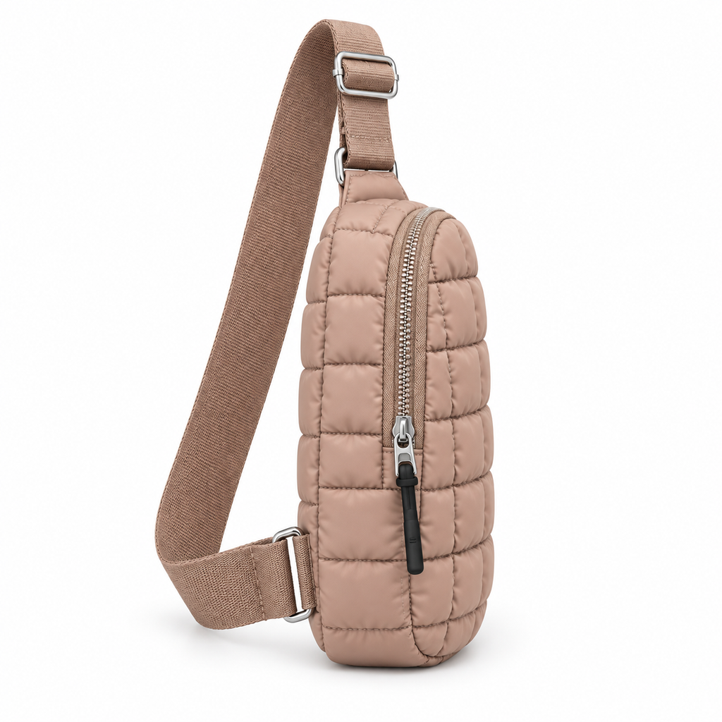 Taupe Quilted Sling Bag side angle view showing soft taupe puffer nylon with grid square quilted pattern, full-length adjustable taupe woven crossbody strap, diagonal main zipper closure with black zipper pull, and bottom silver adjustable buckle on white background
