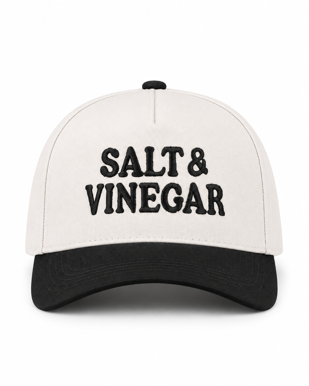 Salt & Vinegar Two-Tone Baseball Cap in Black front view showing cream structured cotton crown with bold black embroidered Salt & Vinegar block lettering, solid black bill, and black top button on white background
