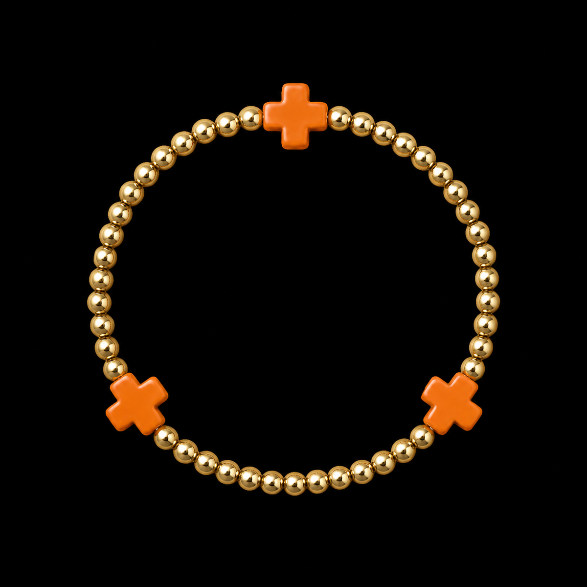 Gold ball bead stretch bracelet with three evenly spaced orange cross accents displayed flat in a circle on black background

