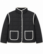 Black Quilted Contrast Trim Jacket front view showing black grid-quilted body with cream contrast trim along all edges, gunmetal snap-button placket, stand-up collar, and two cream-trimmed front patch pockets on white background
