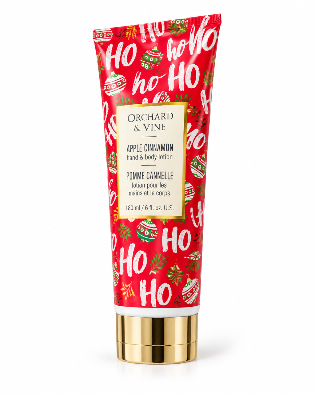 Angled view of the Apple Cinnamon lotion tube showing red Christmas packaging, white HO HO HO lettering, and a gold-tone cap
