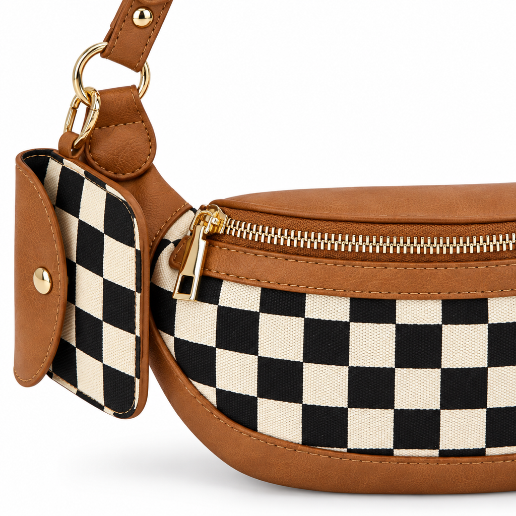 Close-up of Duo Checkered Crossbody Bag in Camel showing gold zipper pull detail along top edge, coordinating black and cream checkered mini wallet clipped to strap with gold carabiner and gold D-ring hardware, and camel tan vegan leather trim with visible stitching on white background
