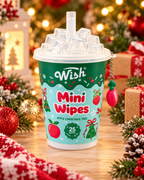 Apple Christmas Tree mini wipes cup displayed among wrapped Christmas gifts, ornaments, evergreen branches, and warm holiday lights
