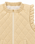 Close-up of the beige vest’s elasticized neckline, front zipper, and ruffled arm opening
