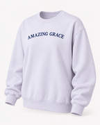 Angled front view of the lavender Amazing Grace crewneck sweatshirt showing long sleeves and ribbed trim
