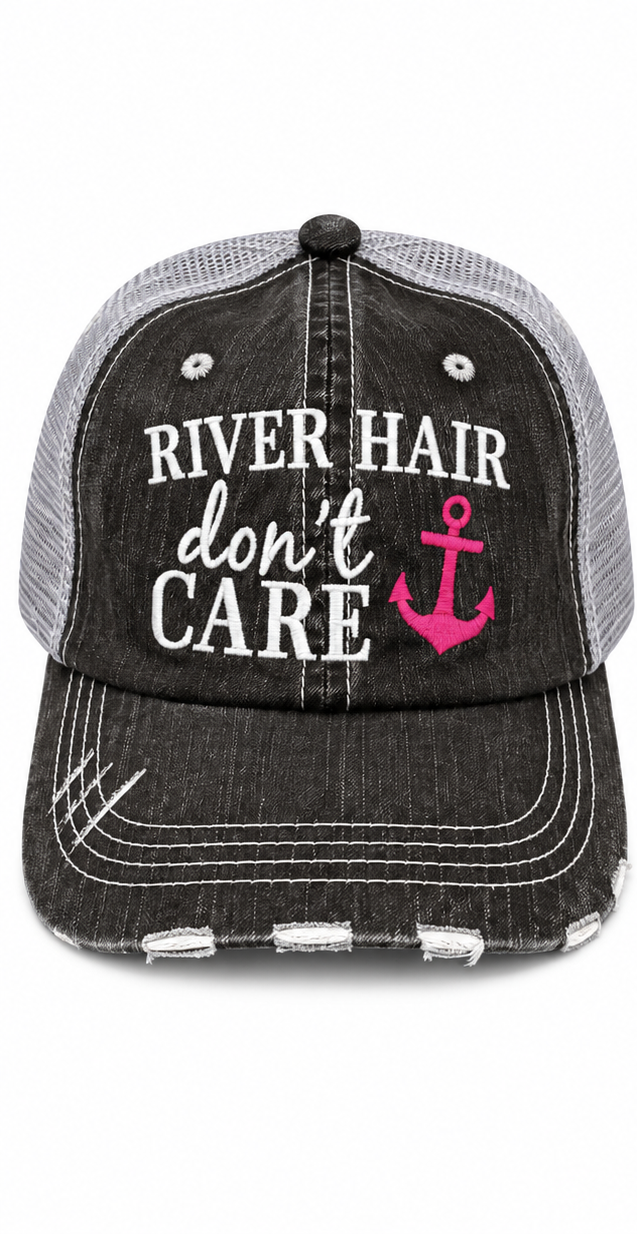 River Hair Don't Care Trucker Hat front view with distressed black structured front, gray mesh back, and white embroidered River Hair Don't Care lettering with hot pink anchor on white background
