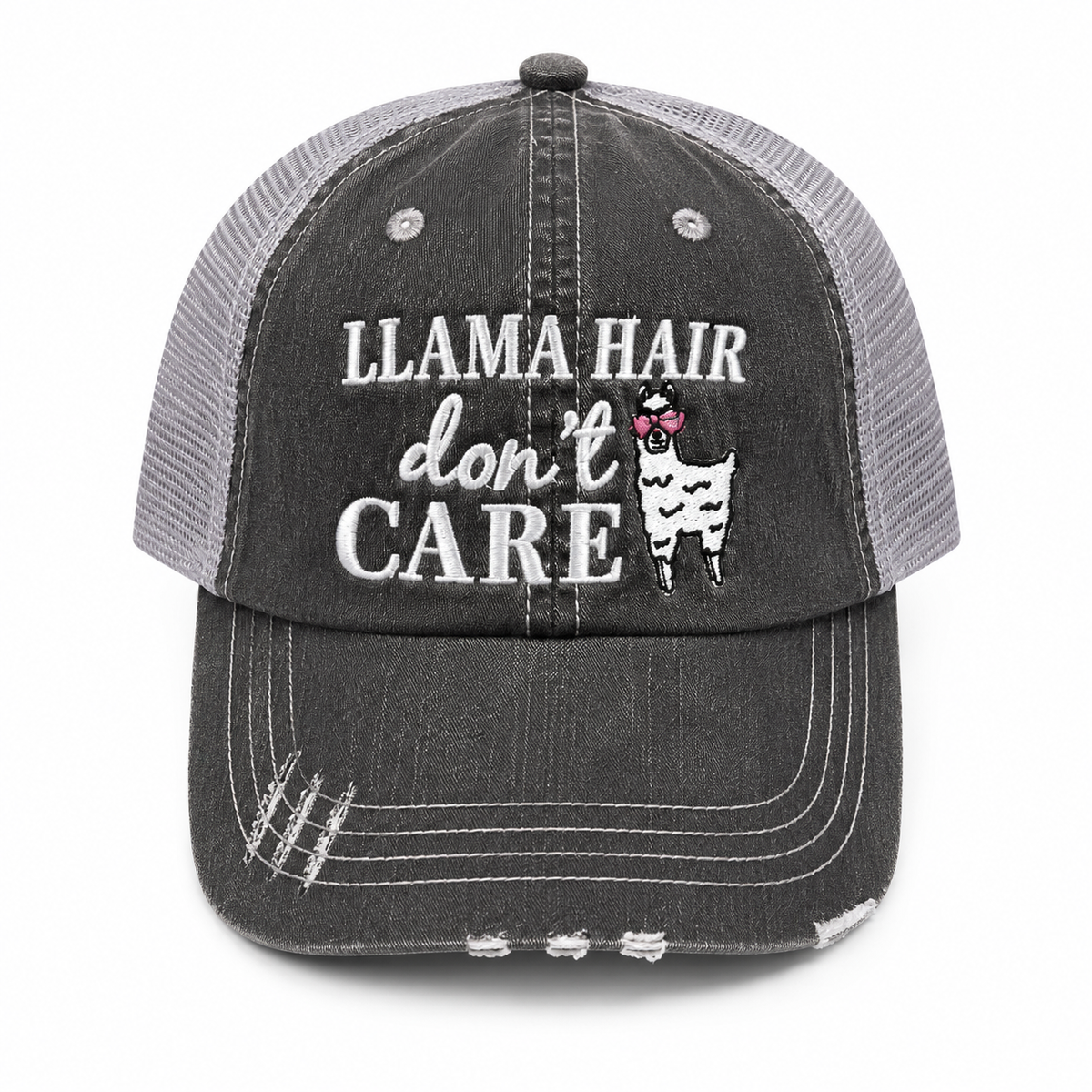 A distressed trucker-style baseball cap with a washed charcoal gray front panel and brim, light gray mesh back, and white embroidered text reading 'LLAMA HAIR don't CARE' with a llama wearing pink heart-shaped sunglasses.