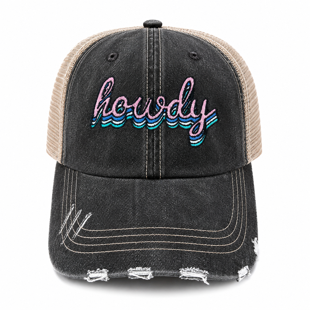 A distressed trucker cap featuring a washed black denim front and brim with frayed details, beige mesh back panels, and 'howdy' embroidered in pink and blue on the front.