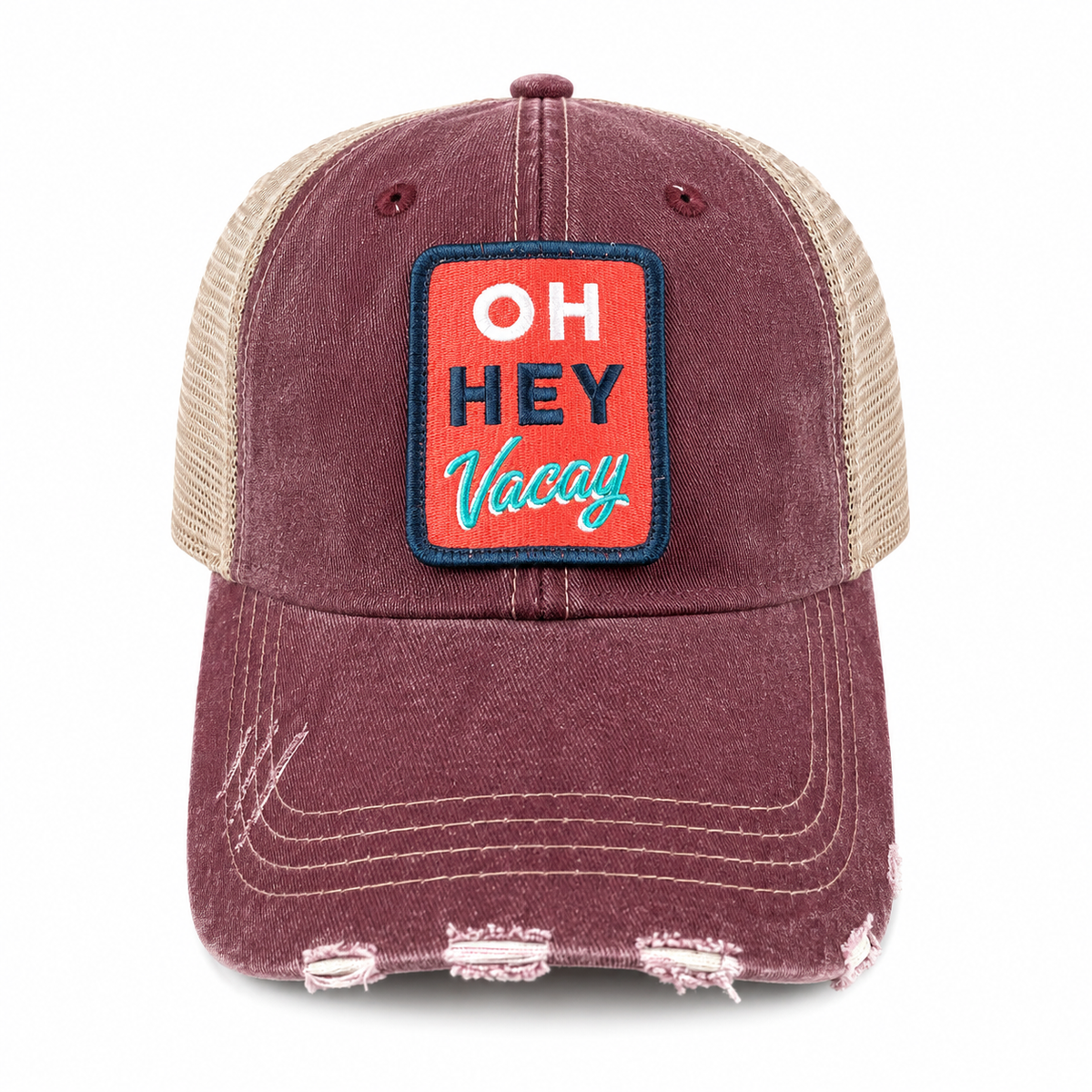 Distressed burgundy trucker hat with tan mesh back and retro Oh Hey Vacay embroidered patch, shown at an angle on a white background.