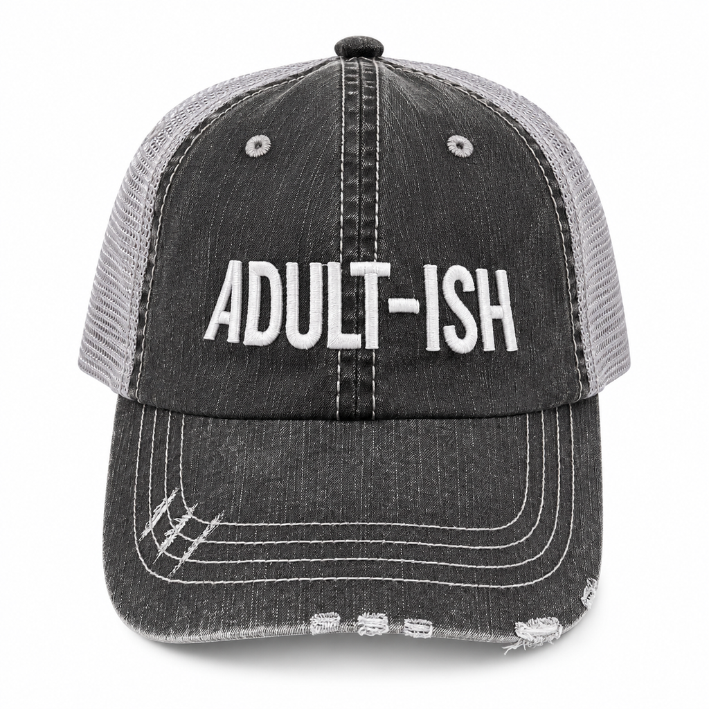 A distressed trucker-style baseball cap with a dark gray washed denim front panel and brim, and light gray mesh back panels. The front features the word 'ADULT-ISH' embroidered in bold white capital letters.
