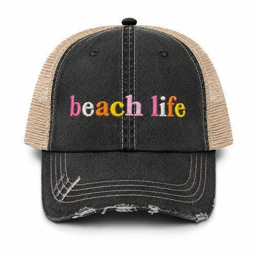 Beach Life trucker hat in distressed black denim front with multicolor embroidered lettering and tan mesh back, shown on a white background.
