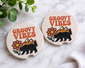Groovy Vibes car coasters with retro bear and flower mountain design