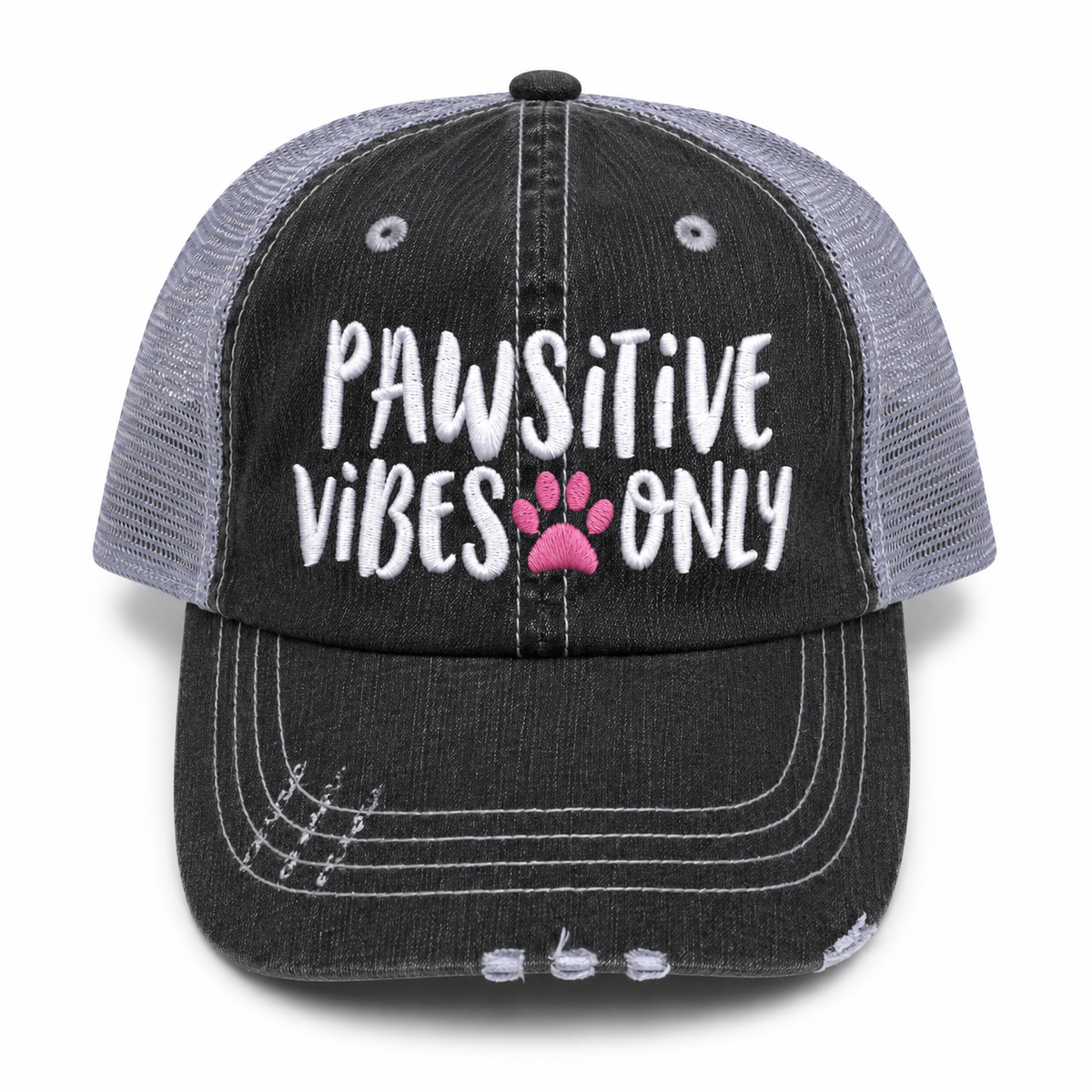 Pawsitive Vibes Only trucker hat in distressed black denim front with white embroidered lettering and pink paw print accent, shown on a white background.
