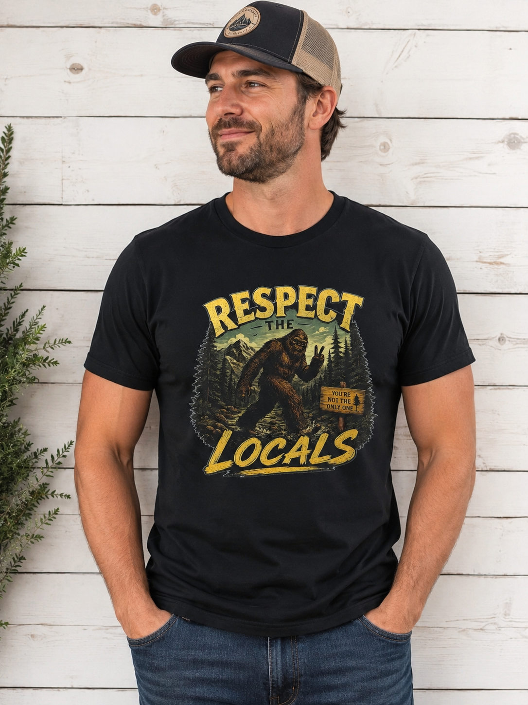 Man wearing Respect the Locals Bigfoot graphic tee in black