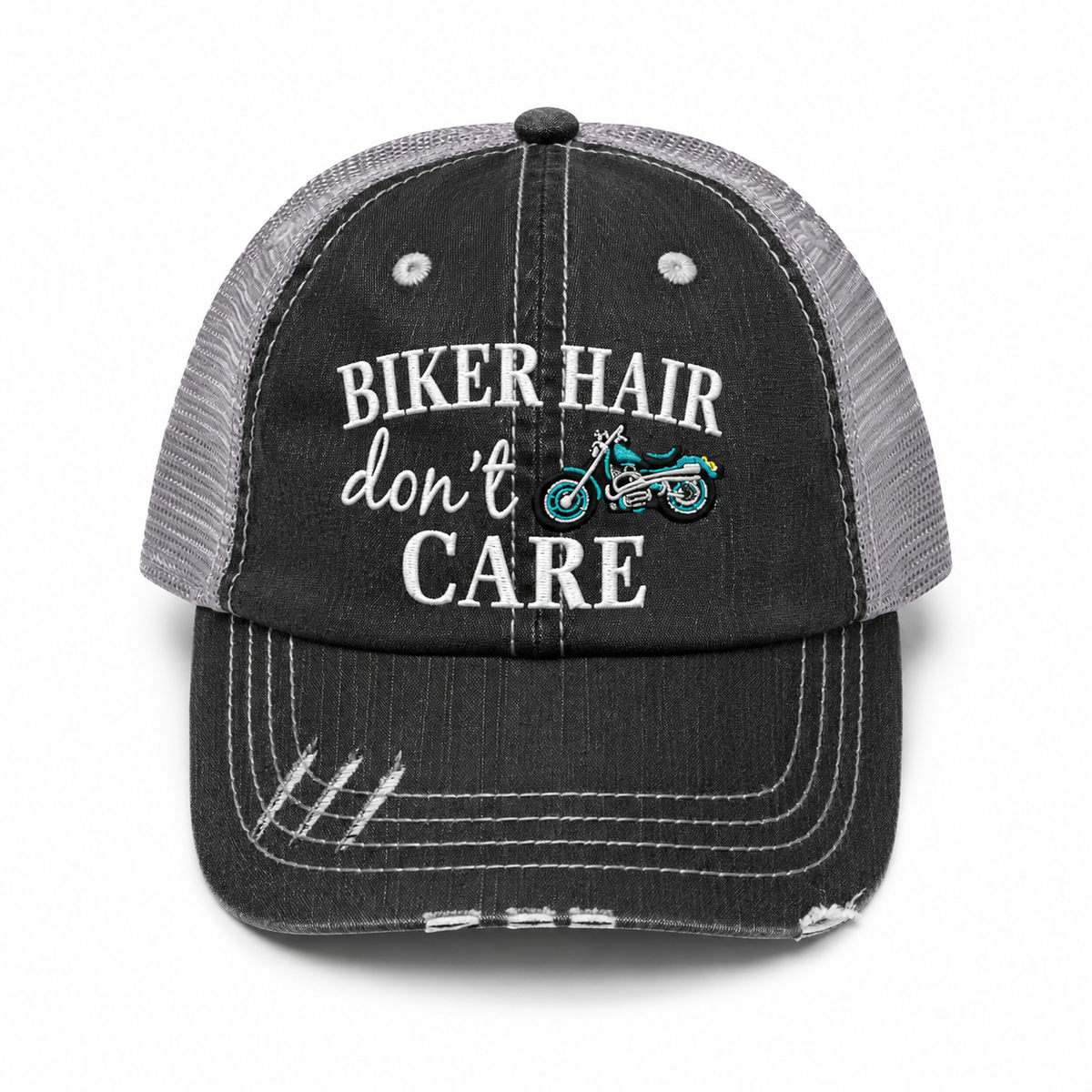 A distressed trucker hat with a washed black front panel and brim, gray mesh back, and white embroidered text reading 'BIKER HAIR don't CARE' with a small colorful motorcycle graphic.