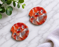 Resin Chicken Art car coasters with swirling orange and white resin and chicken faces