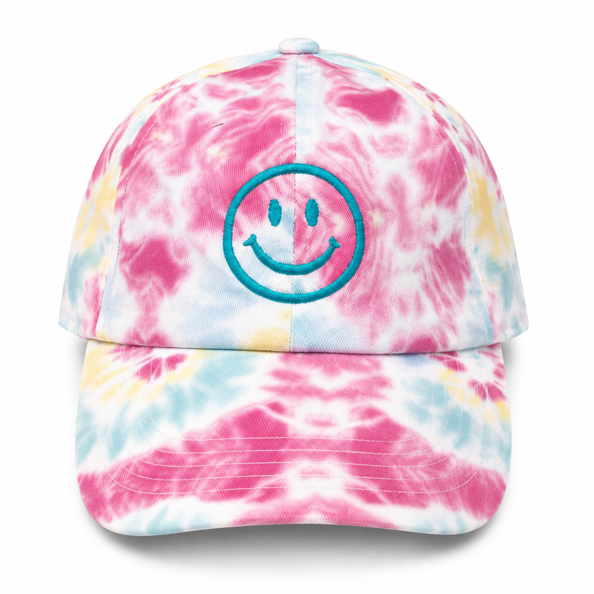Tie-Dye Smiley Face Cap in vibrant pink, blue, and yellow tie-dye with embroidered teal smiley face, shown on a white background.


